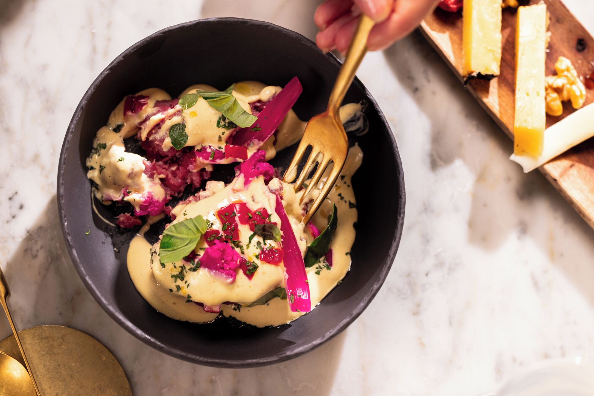 A bowl of food with a fork and a spoon.