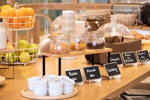 A breakfast buffet with various food items and labels. - Le Phenix Hotel (Lyon)