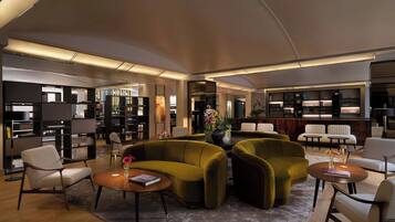 A modern library with sofas, tables, and bookshelves.
