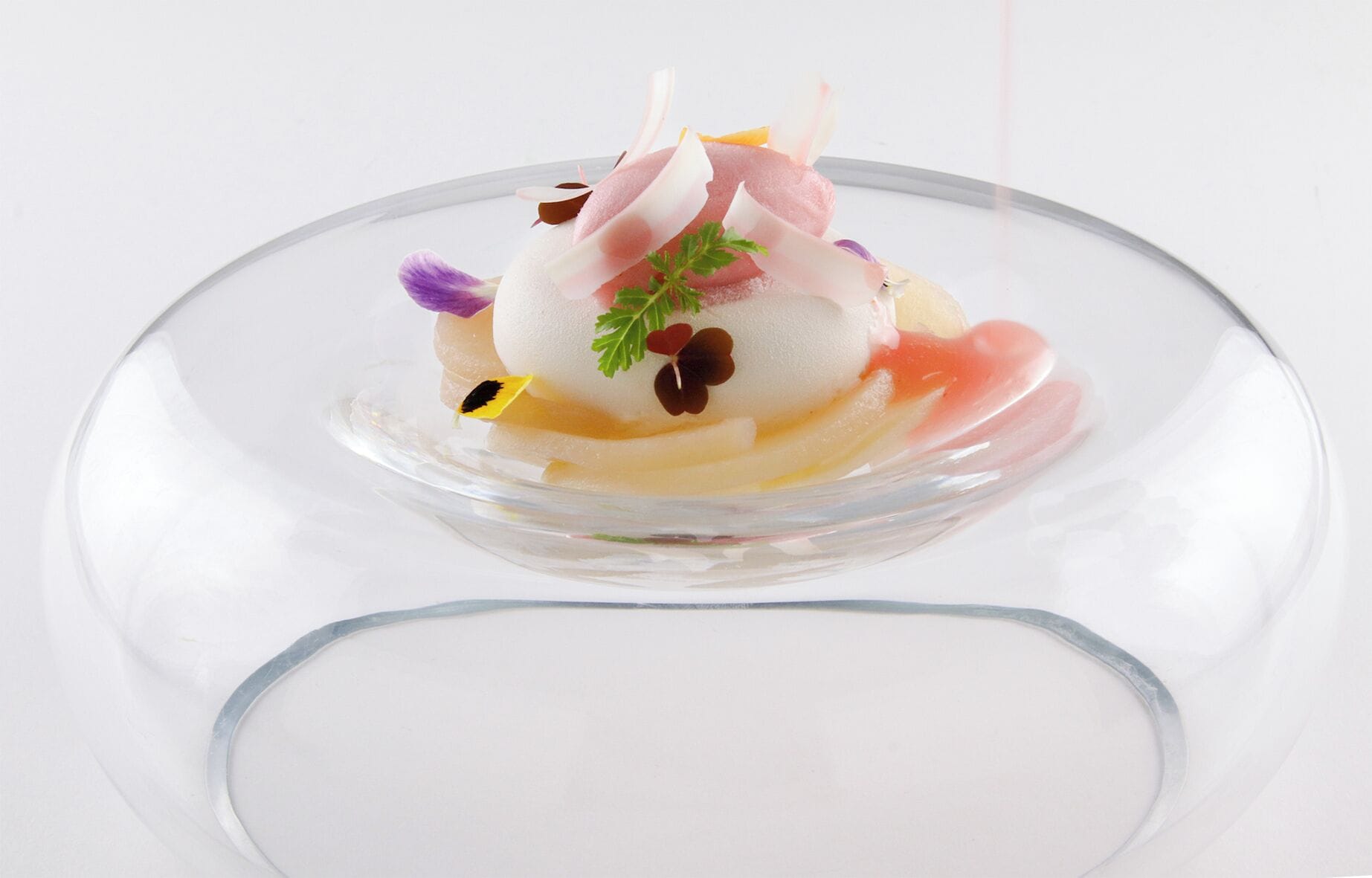 A dessert on a clear glass plate.