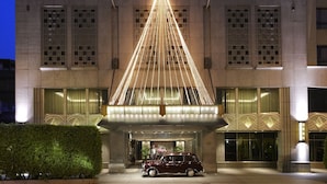 A hotel entrance with a prominent lighted archway and a classic car parked in front. - The Landis Taipei (Taipei)
