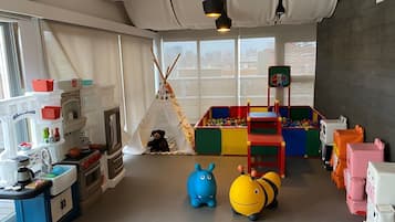 Children can play and explore in this spacious room featuring a teepee, playhouse, and ball pit.