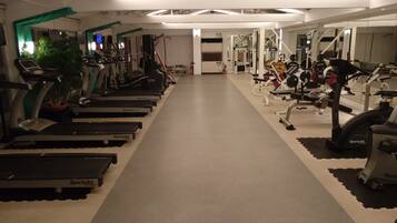 A gym with treadmills, ellipticals, and weight machines.