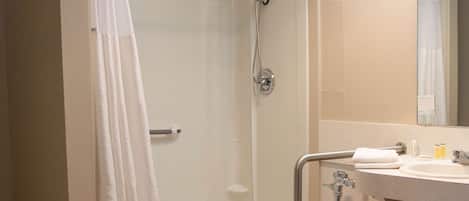 A bathroom with a shower, toilet, and sink.