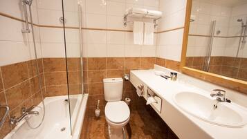 A bathroom with a bathtub, toilet, and sink.