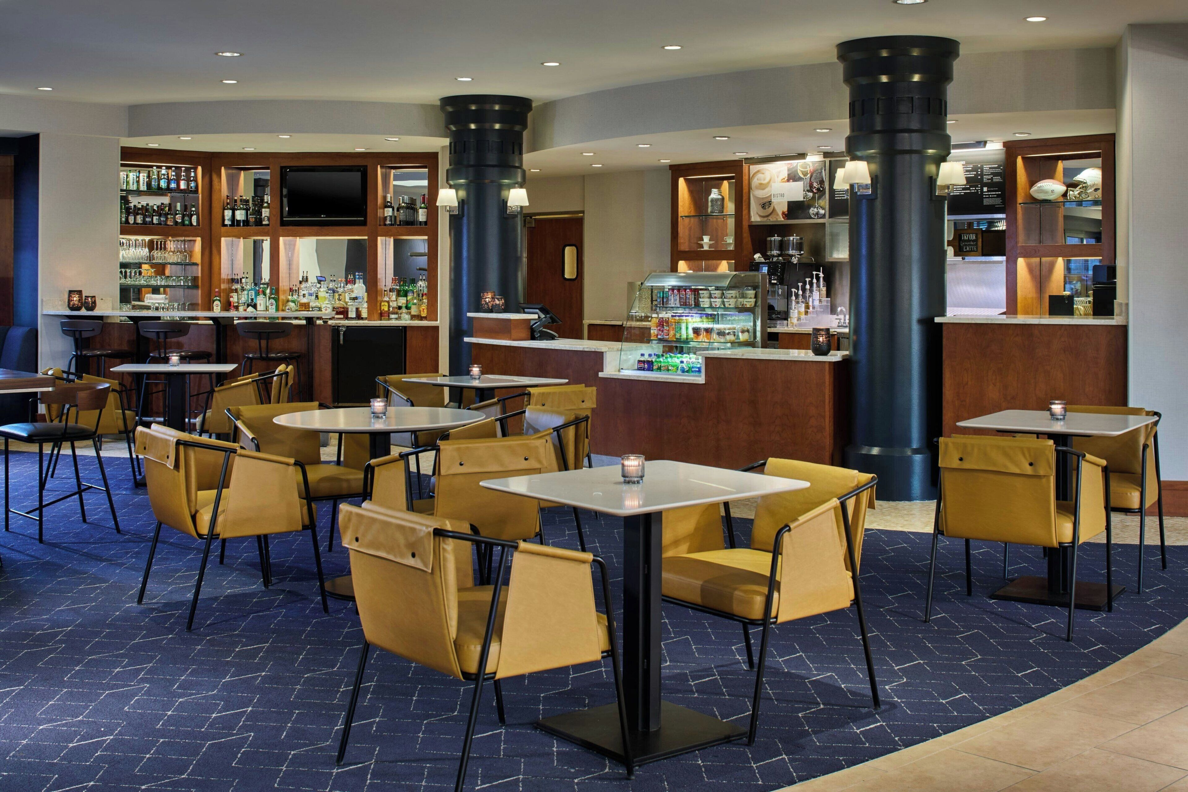 A bar area with seating, a television, and a variety of beverages.