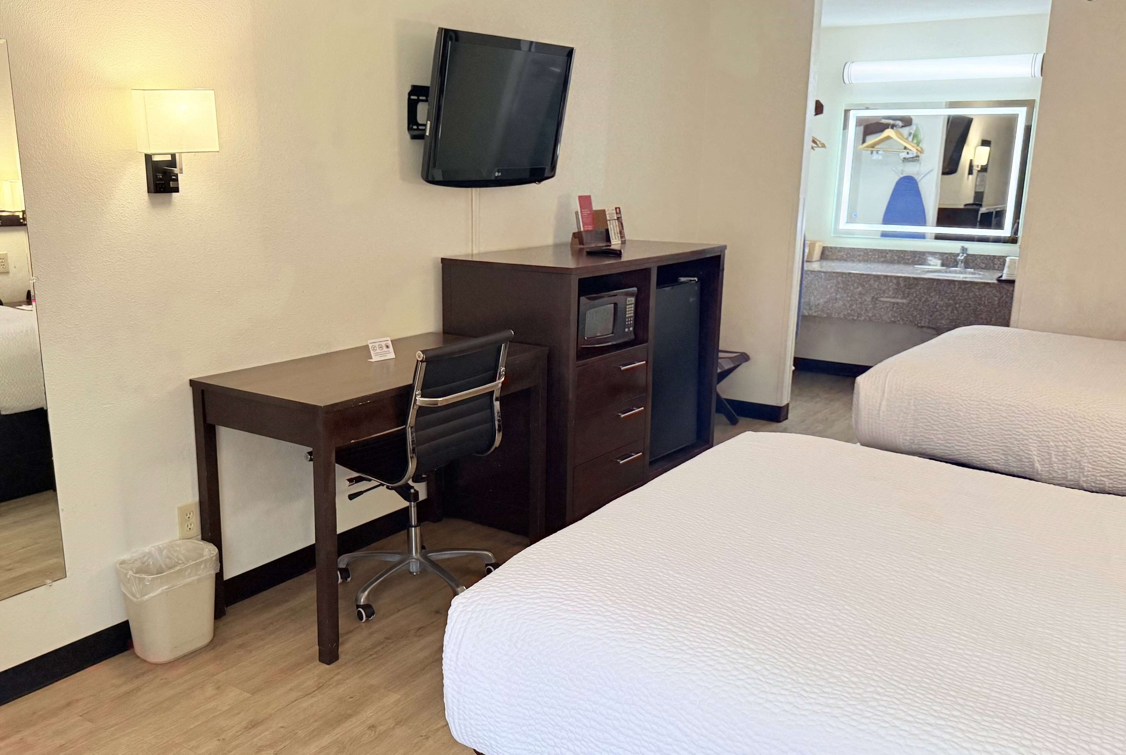 deluxe room, 2 queen beds | in-room safe, laptop workspace, blackout curtains, iron/ironing board