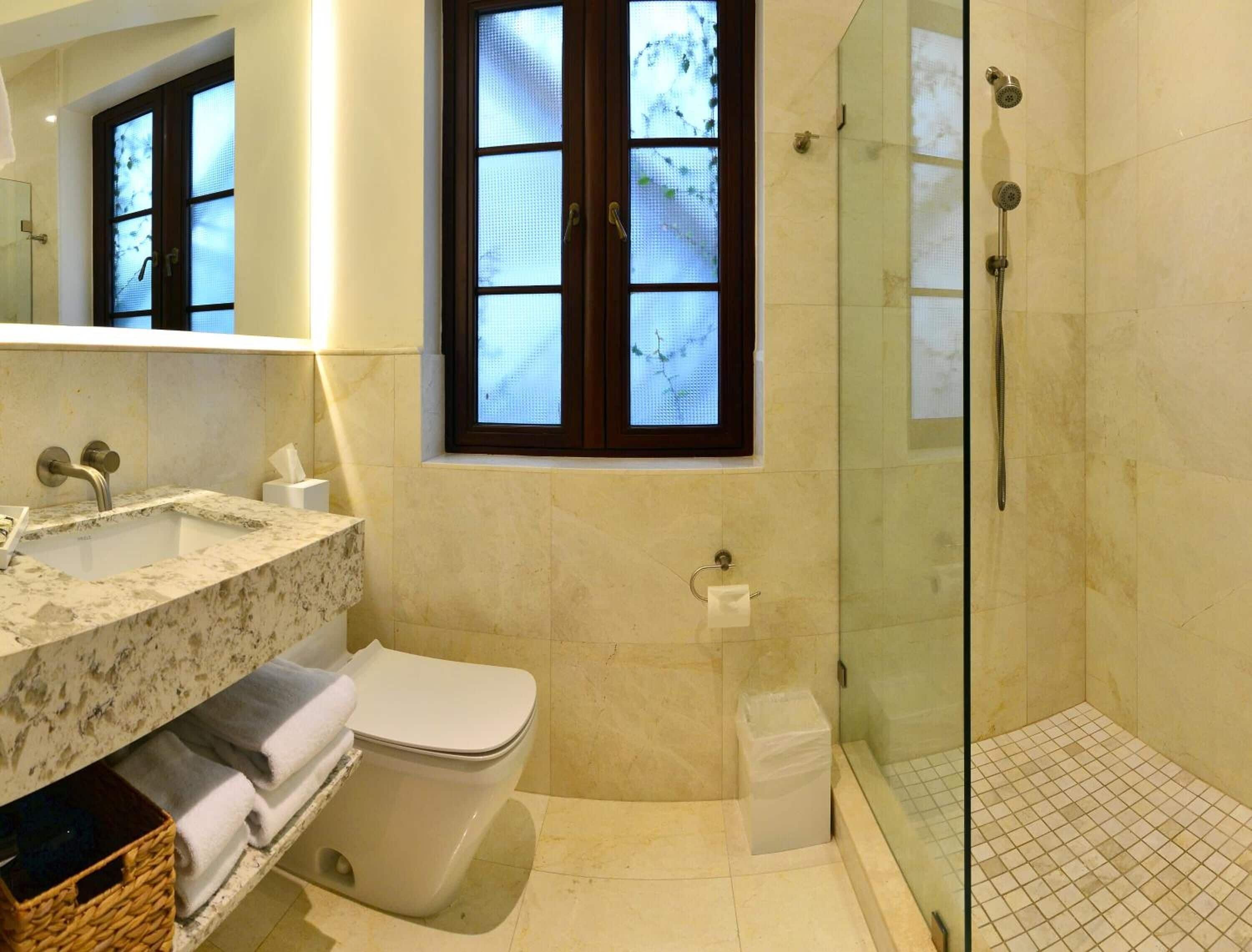 rainfall showerhead, designer toiletries, hair dryer, towels