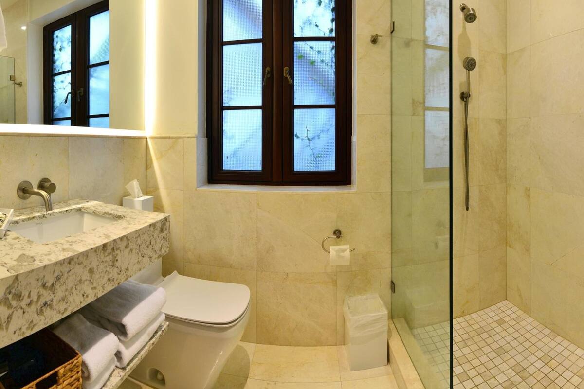 rainfall showerhead, designer toiletries, hair dryer, towels