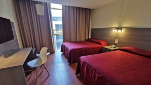 A hotel room with two beds, a desk, a chair, and a window with curtains. - Hotel del Angel Reforma (Mexico City)
