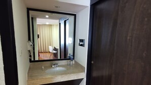 A bathroom with a sink, mirror, and wooden floor. - Hotel del Angel Reforma (Mexico City)