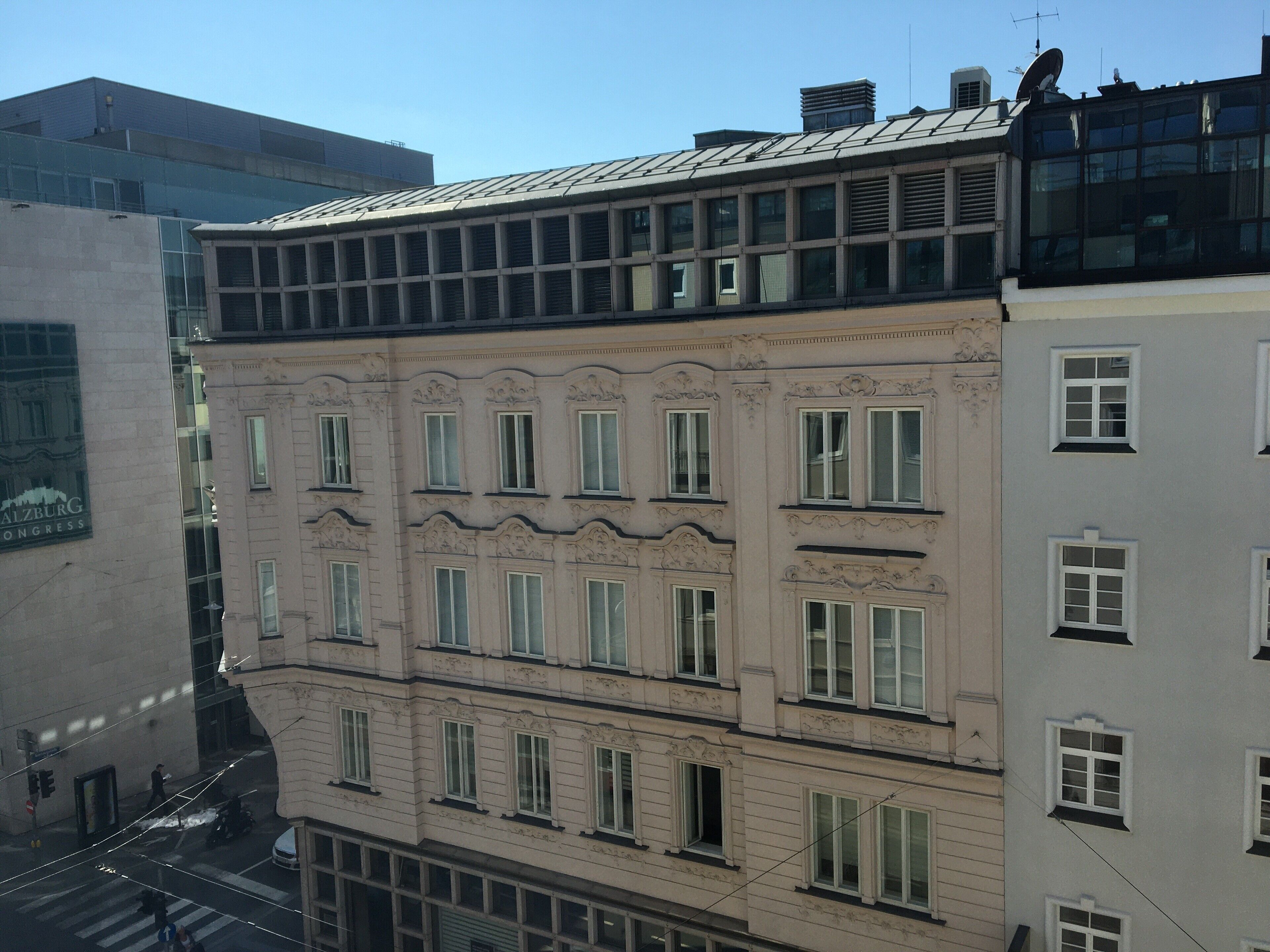 A multi-story building with a classical architectural style, featuring ornate window frames and decorative moldings.