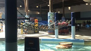 An indoor area with a pool, ropes, and a sign indicating 'Exit Only' and 'Re-entry'. - Soaring Eagle Waterpark and Hotel (Mount Pleasant)