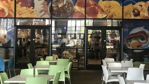 A restaurant with a sign reading "Wisindaa Let Us Eat" and a menu board displaying food items. - Soaring Eagle Waterpark and Hotel (Mount Pleasant)