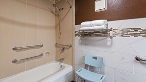 A bathroom with a bathtub, a shower with grab bars, a toilet with a raised seat, and a towel rack with folded towels. - Best Western Murfreesboro (Murfreesboro)
