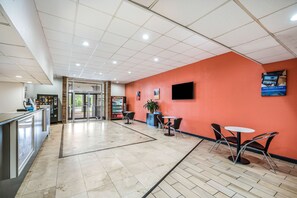 Relax in the hotel lobby, where a reception desk and seating area await.