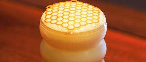 A stack of three cylindrical objects with a honeycomb pattern on top, placed on a wooden surface.