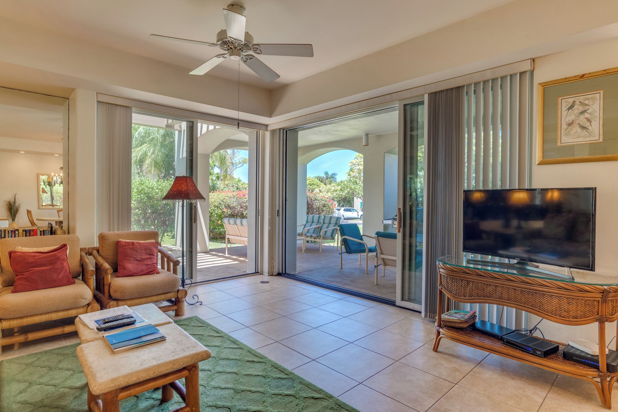 A spacious living room with a sofa, a coffee table, and a television on a glass table.