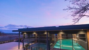 A modern building with a glass-enclosed swimming pool and a view of the landscape. - Boringdon Hall Hotel and Spa (Plymouth)