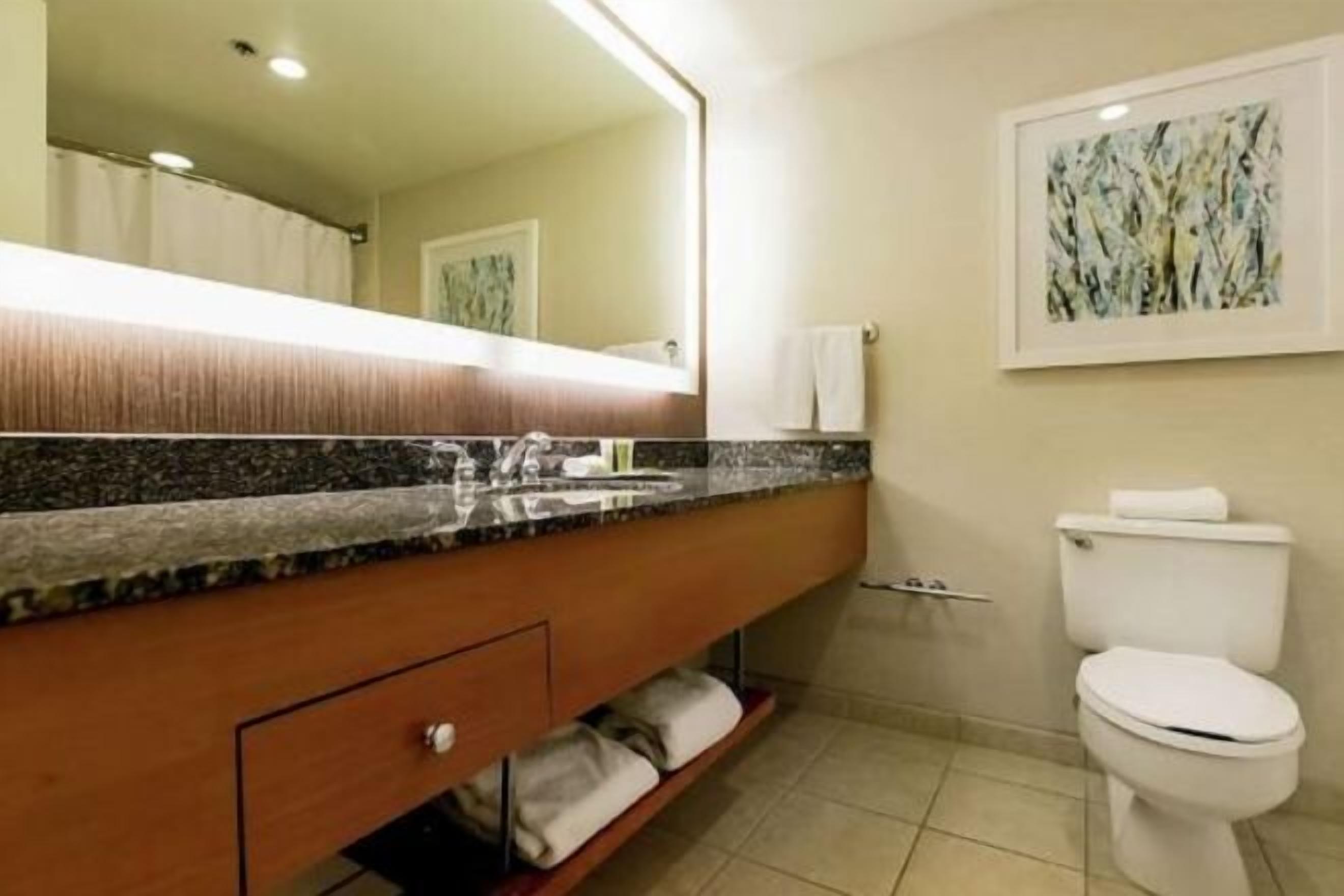 Designer toiletries, hair dryer, slippers, towels