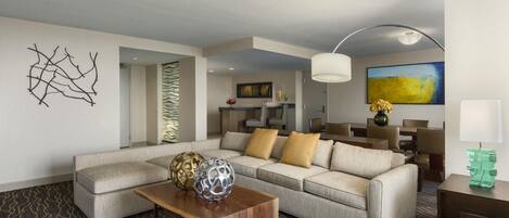 A modern living room with a sectional sofa, a coffee table, and decorative items.