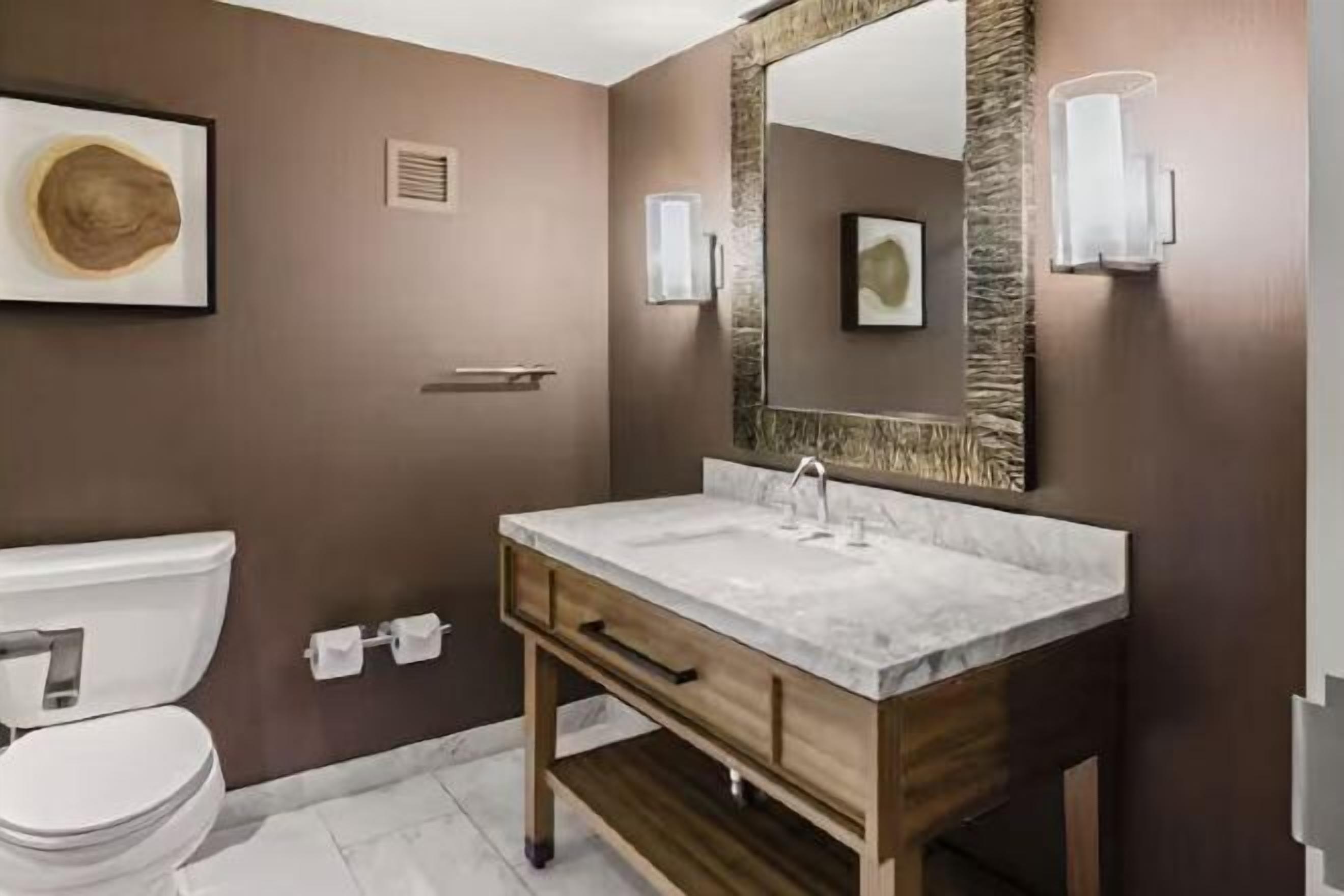 Bathroom | Designer toiletries, hair dryer, slippers, towels