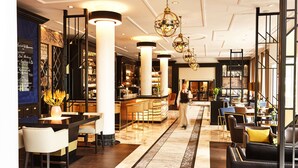 A modern hotel lobby with a bar area, seating arrangements, and a staircase. - Steigenberger Hotel Bad Homburg (Bad Homburg v.d. Hoehe)