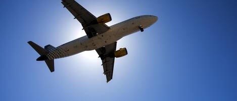 An airplane in flight against a clear blue sky.
