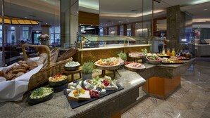 A buffet with various food items and a seating area with tables and chairs. - Parkhotel Pforzheim (Pforzheim)