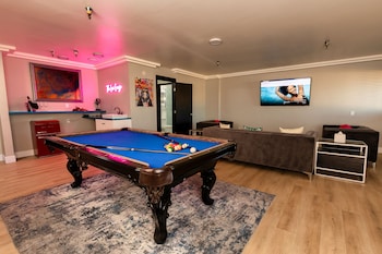 Lexi Suite | Living area | 56-inch Smart TV with satellite channels at Lexi Las Vegas