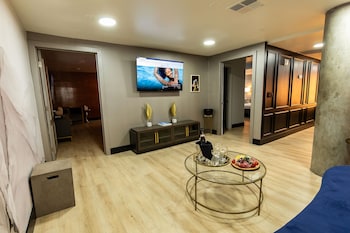 A modern lobby with a green wall, white columns, and a tiled roof. at The Lexi Las Vegas, Trademark Collection by Wyndham