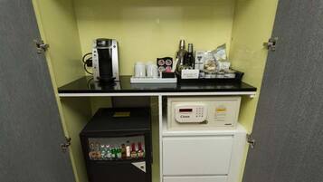 A kitchenette with a coffee maker, a mini-fridge, and a microwave.