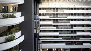 A multi-level hotel interior with balconies, a central atrium, and a modern architectural design. - Embassy Suites by Hilton Los Angeles International Airport North (Los Angeles)