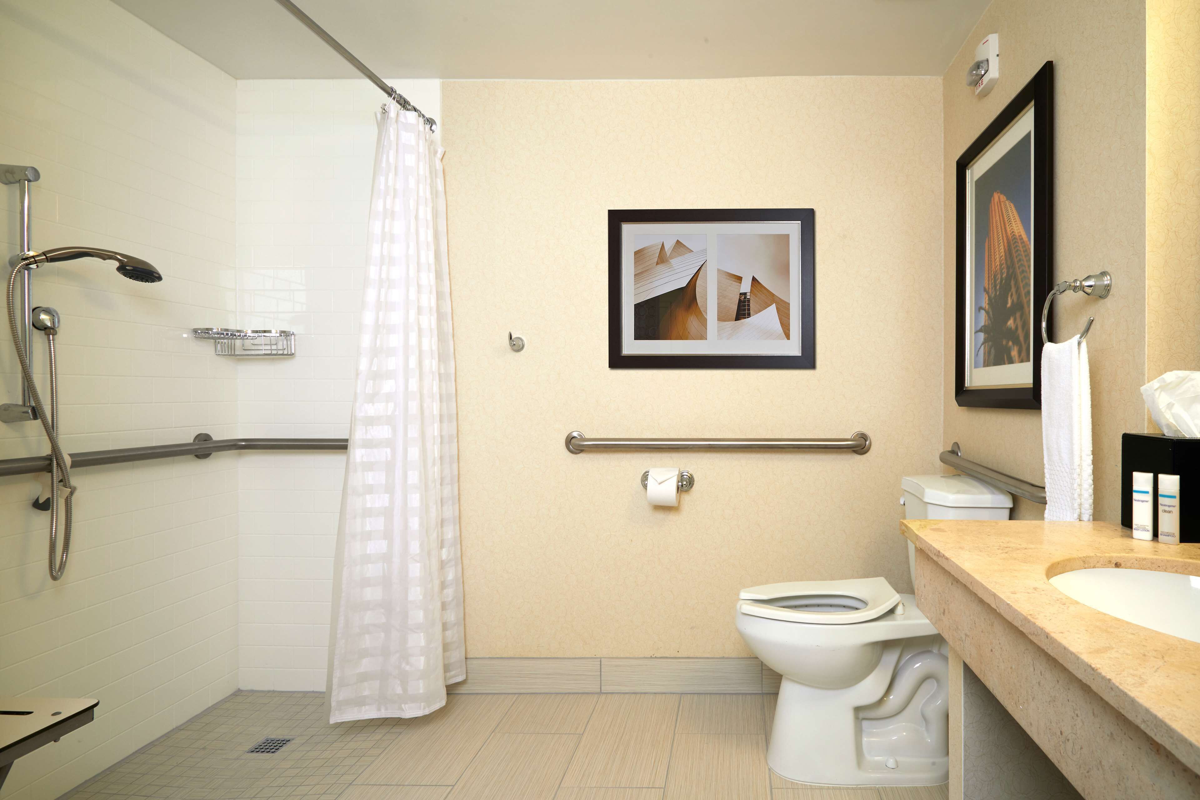 A bathroom with a shower, toilet, and sink.