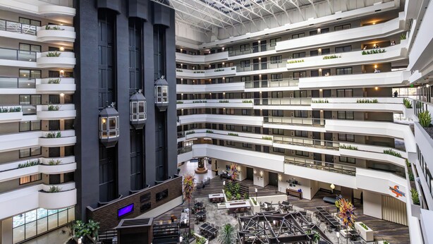 A multi-level atrium with balconies, seating areas, and a central open space. - Embassy Suites by Hilton Los Angeles International Airport North (Los Angeles)