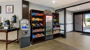 A clean, well-lit lobby with an ATM, a refrigerated beverage display, and snack shelves. - Best Western Albemarle Inn (Albemarle)
