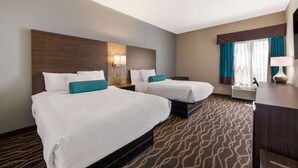 A hotel room with two beds, a desk, and a large window with curtains. - Best Western Albemarle Inn (Albemarle)