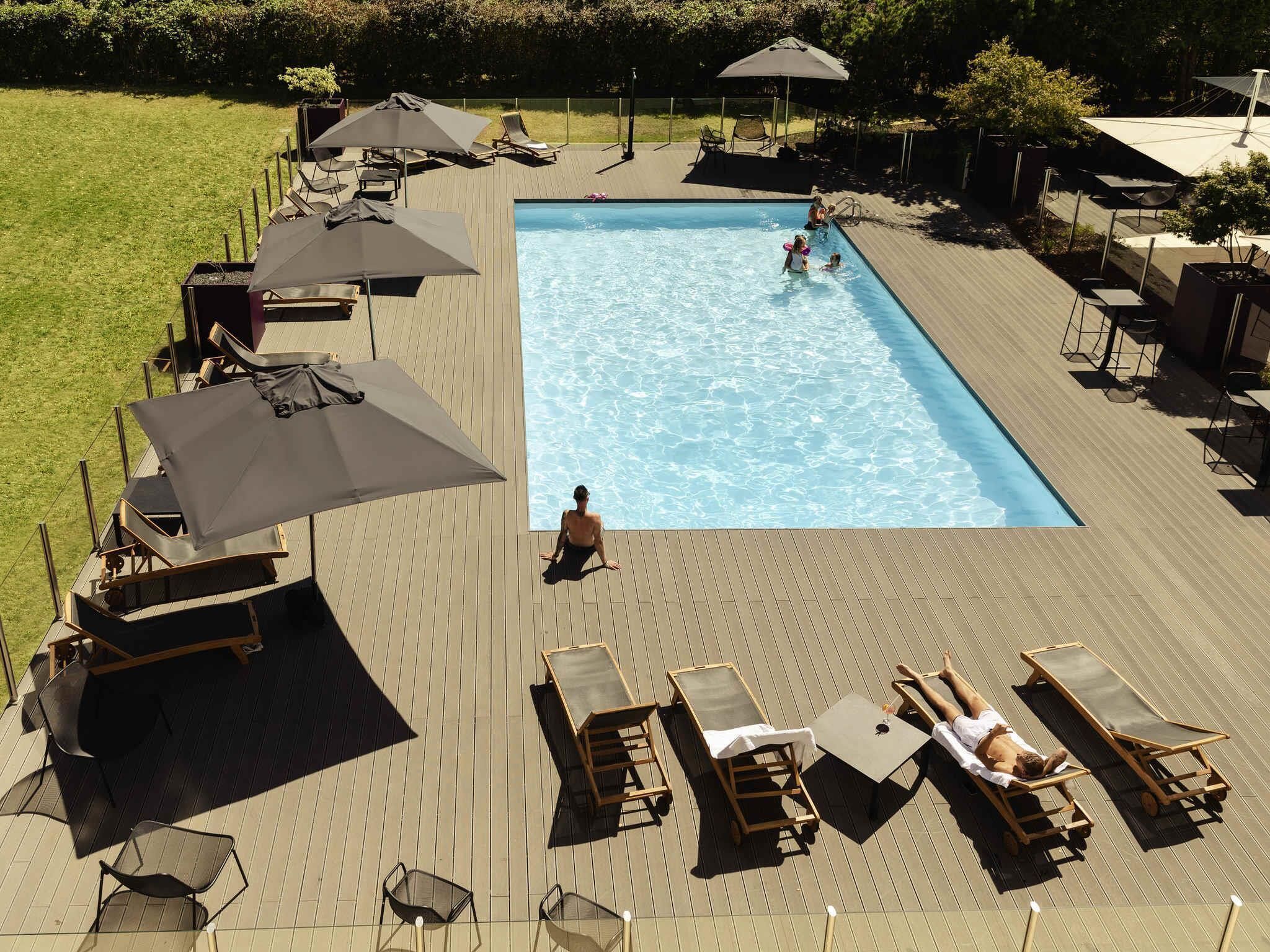 Seasonal outdoor pool, open 9:00 AM to 10:00 PM, pool umbrellas