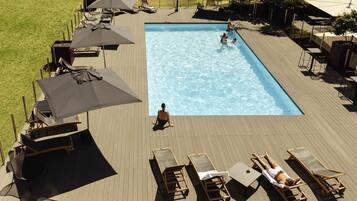 Seasonal outdoor pool, open 9:00 AM to 10:00 PM, pool umbrellas