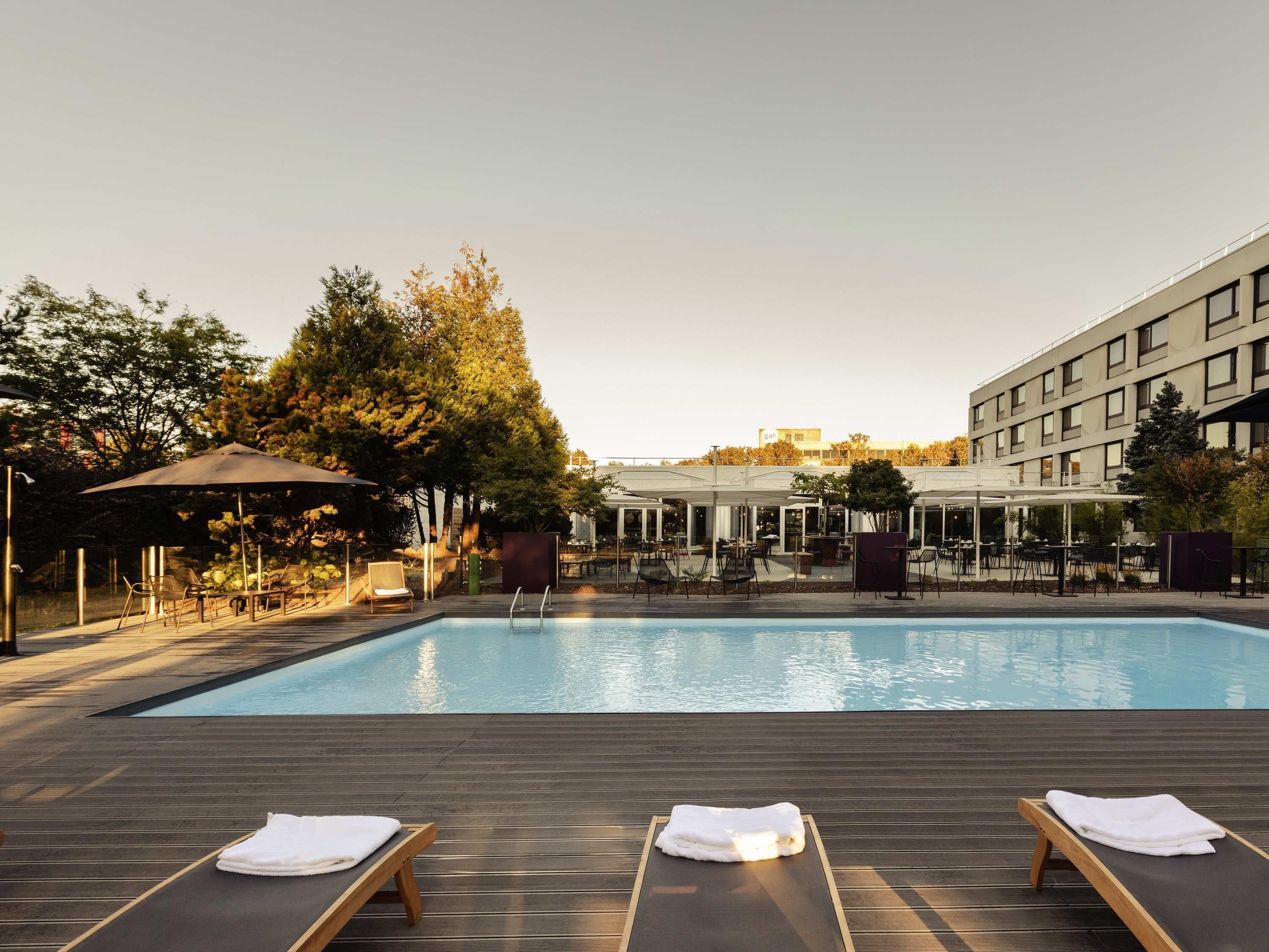 Seasonal outdoor pool, open 9:00 AM to 10:00 PM, pool umbrellas