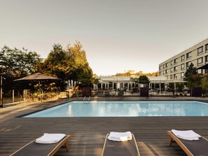 Seasonal outdoor pool, open 9:00 AM to 10:00 PM, pool umbrellas