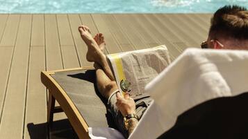 Seasonal outdoor pool, open 9:00 AM to 10:00 PM, pool umbrellas