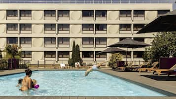 Seasonal outdoor pool, open 9:00 AM to 10:00 PM, pool umbrellas