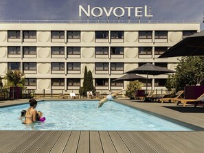 Seasonal outdoor pool, open 9:00 AM to 10:00 PM, pool umbrellas