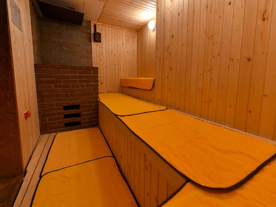 A sauna room with wooden walls and benches.