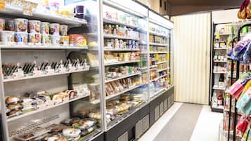 A refrigerated section in a store with various packaged foods and beverages.