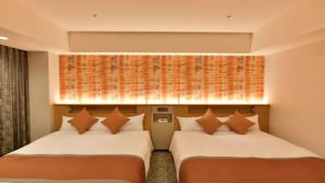 A hotel room with two beds, a headboard with a phone, and a patterned wall above the beds.