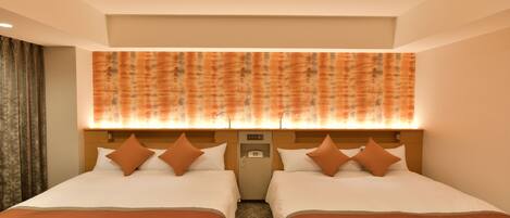 A hotel room with two beds, a headboard with a phone, and a patterned wall above the beds.