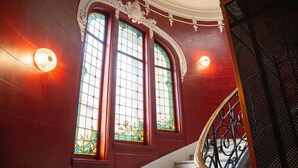 A staircase with ornate metal railings and stained glass windows. - Grand Hôtel du Midi Montpellier - Opéra Comédie (Montpellier)