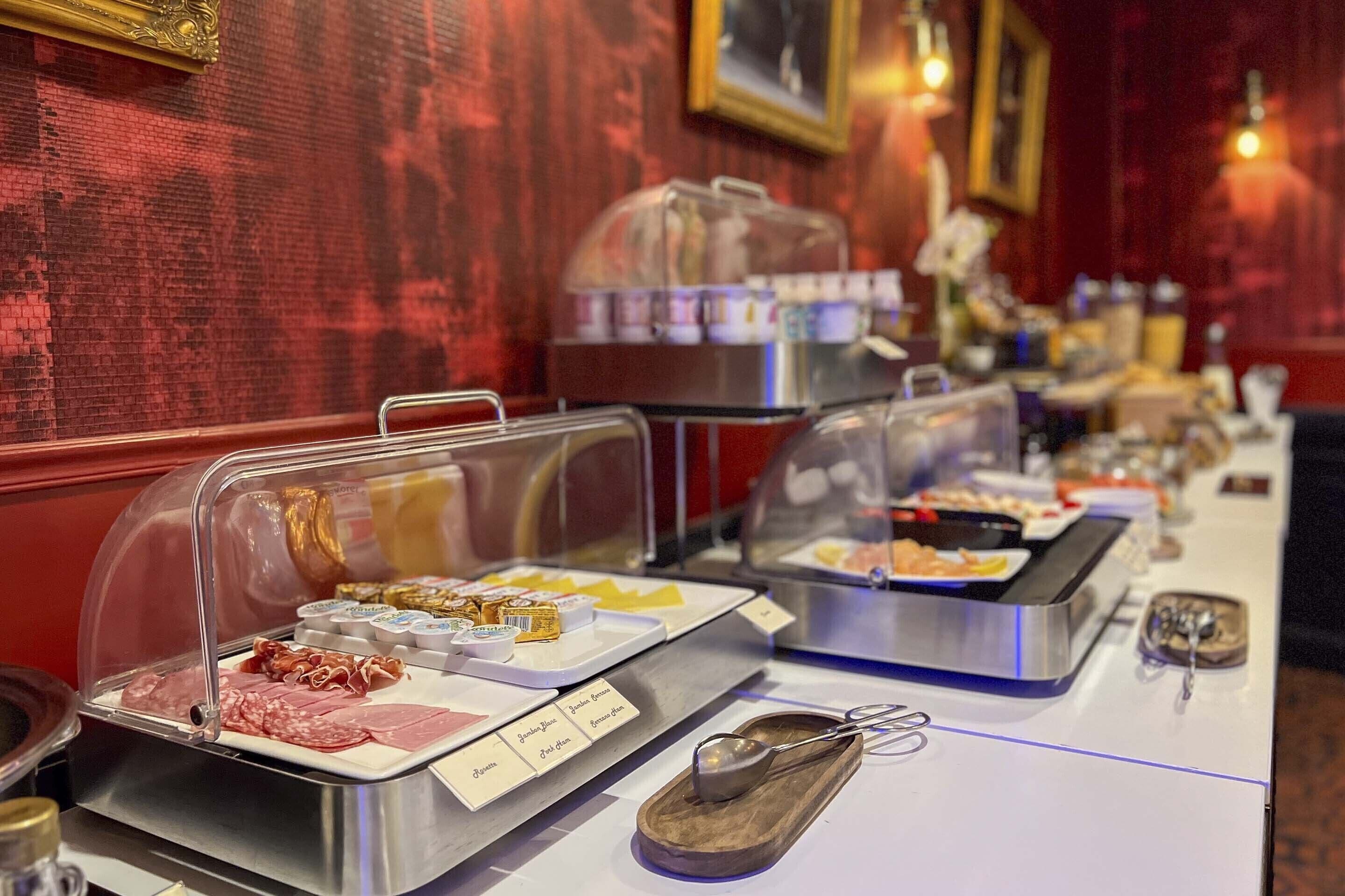 A buffet with various food items and condiments.